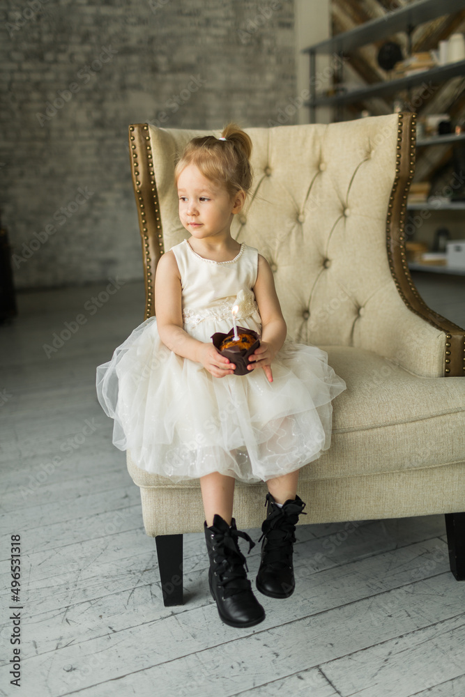 little girl celebrates her birthday. blows out the candle on the cake