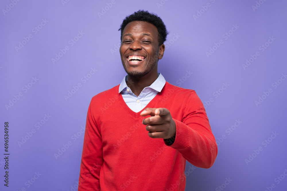 Laughing young african american man pointing index finger on camera Laughing young african american man pointing index finger on camera