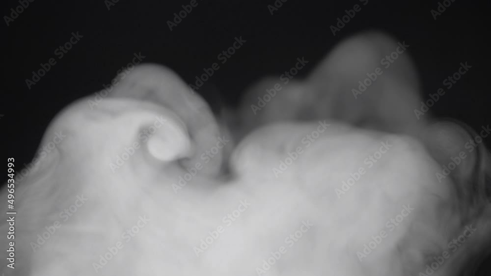 Smoke billowing over a black background.
Smoke on black background in slow motion. Smoke billowing over a black background.
Smoke on black background in slow motion.