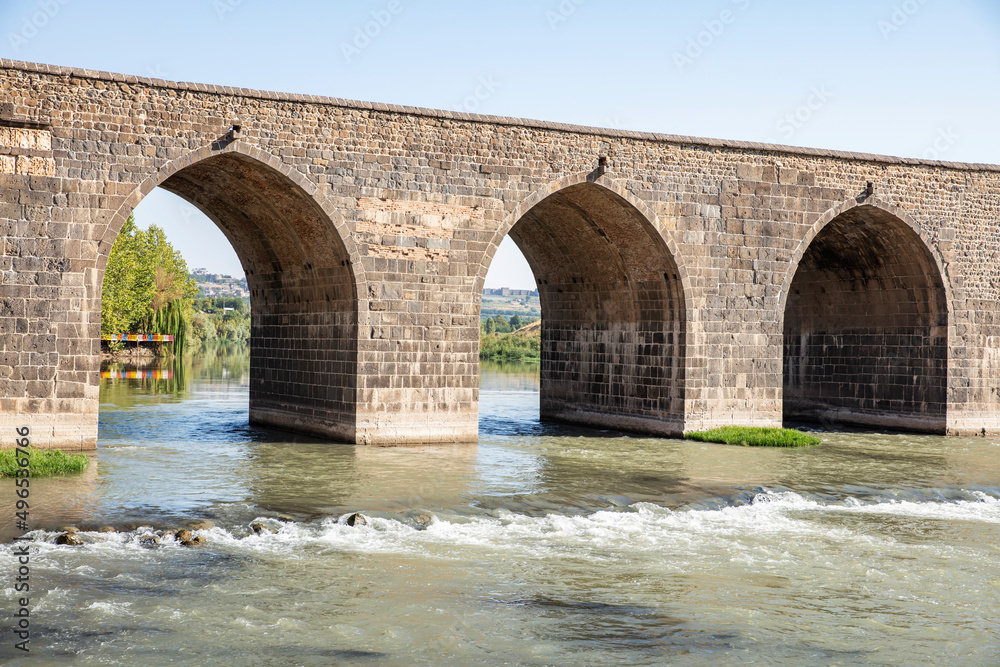 Historical Diyarbakır ten-eyed bridge and reflection of the Tigris river