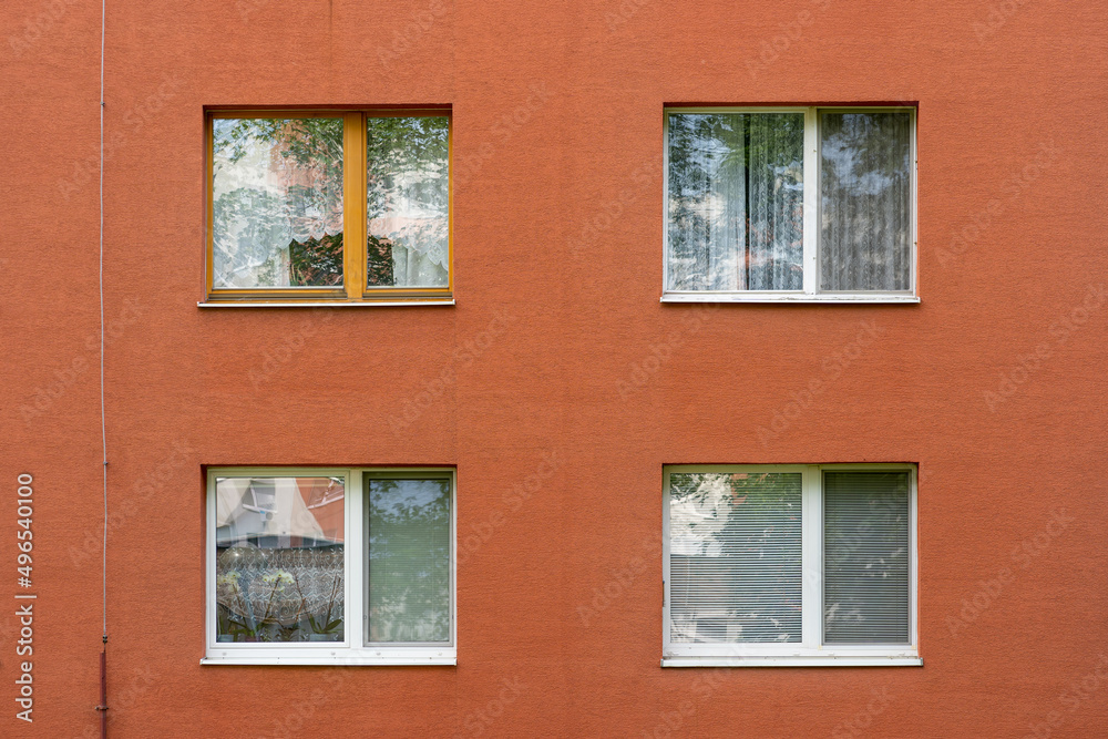 four white windows of an apartmnent house in Slovakia