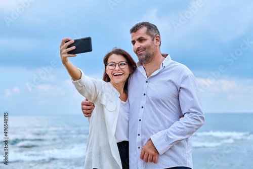 Happy mature couple taking selfie photo on smartphone. © Valerii Honcharuk