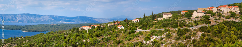Panoramic banner image of Hvar island in Croatia. Aerial view on mountains and coastline with blue water. Bird view panoramic image taken from old mountain road to Hvar.