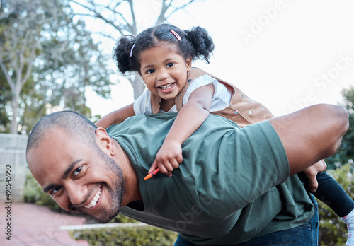 Were always in the mood for some fun. Shot of a man carrying his daughter on his back while standing outside. © N Felix/peopleimages.com