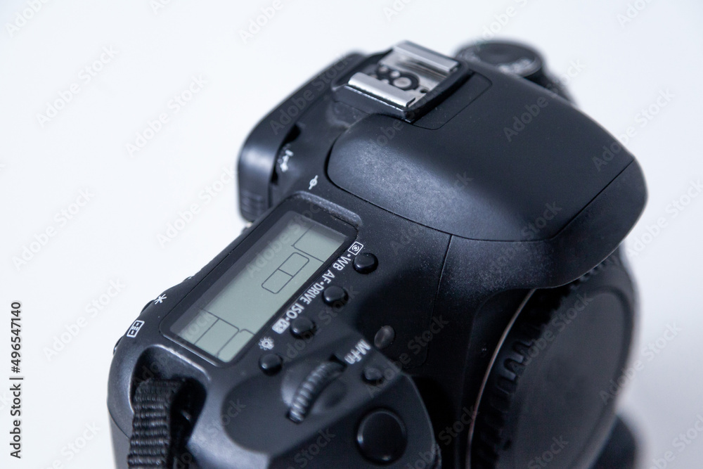DSLR camera body in black color on white background. DSLR camera with battery grip attached.
