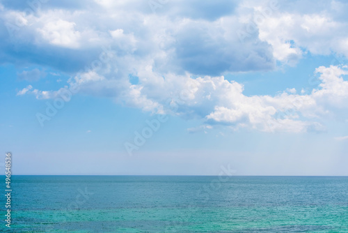Photo of a cloudy sky above the multi-colored water of the Black sea in Ukraine