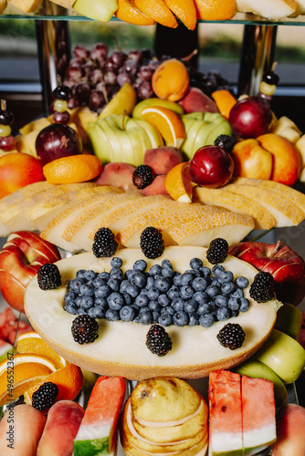 Buffet reception fruit for a wedding. Assortment of exotic fruits. Fresh fruits decoration.