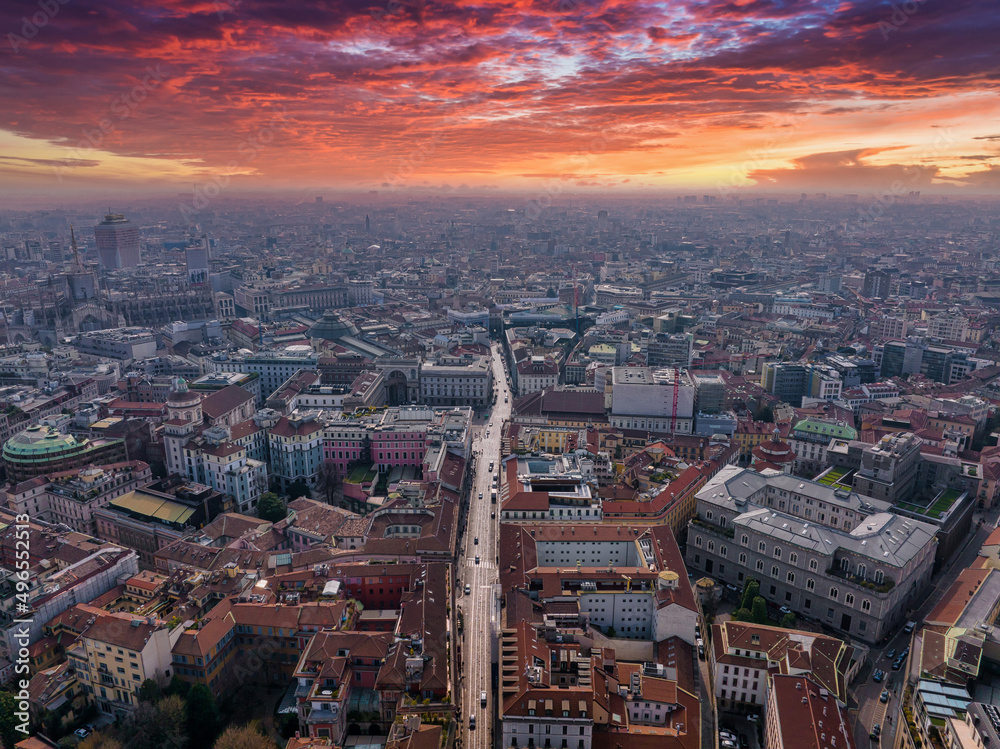 Obraz premium Aerial view of Piazza Duomo in front of the gothic cathedral in the center. Drone view of the gallery and rooftops during the day. Milan. Italy,