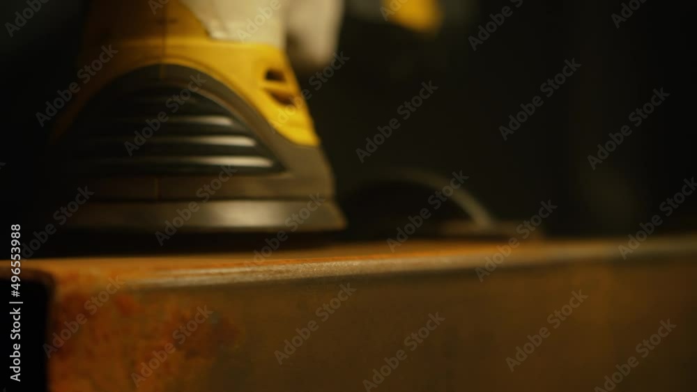 Worker polishing metal with grinder. Interior of a heavy industry factory with a worker using a grinder. Electric grinding of steel pipes in a factory. Slow motion. Close up. 4K video. Shot on RED