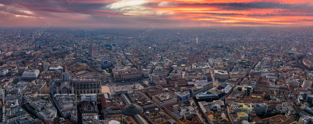 Obraz premium Aerial view of Piazza Duomo in front of the gothic cathedral in the center. Drone view of the gallery and rooftops during the day. Milan. Italy,