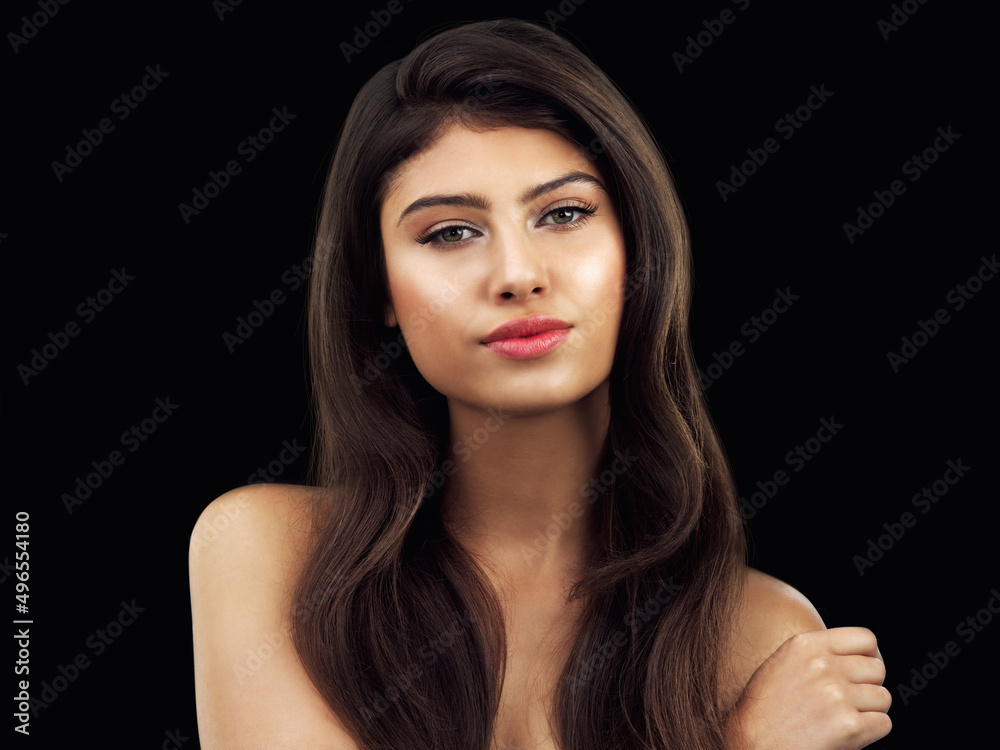 Her beauty will intrigue you. Studio shot of a beautiful woman touching her shoulder posing against a black background. Her beauty will intrigue you. Studio shot of a beautiful woman touching her shoulder posing against a black background.
