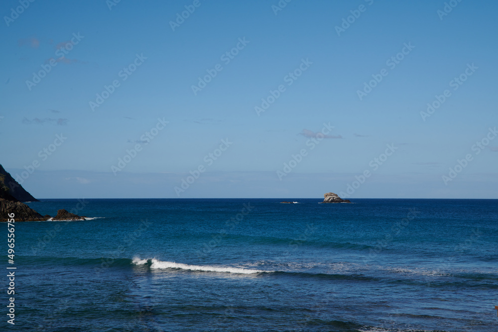 Fototapeta premium The chopping waves of the sea and the little tiny boat riding the waves.
