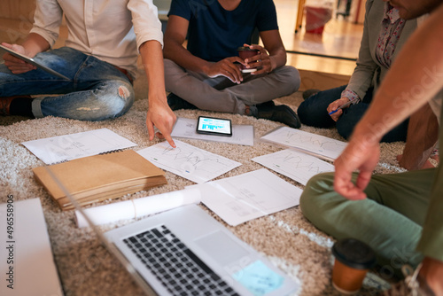 Thorough planning is a key step you cant neglect. Closeup shot of a group of unrecognisable businesspeople brainstorming on the floor in an office.