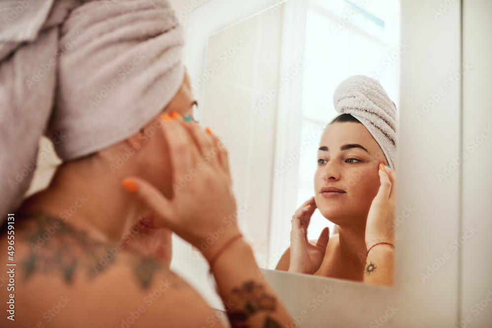 What you do is a reflection of you. Shot of an attractive young woman inspecting her face in the bathroom mirror. What you do is a reflection of you. Shot of an attractive young woman inspecting her face in the bathroom mirror.
