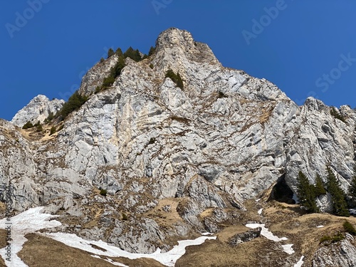 Rocky peak Dejenstogg or Dejenstock (2022 m) in the Glarus Alps mountain range, over the Klöntalersee (or Kloentalersee) reservoir lake and Klöntal alpine valley - Canton of Glarus, Switzerland photo