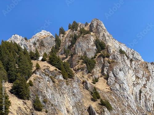 Rocky peak Dejenstogg or Dejenstock (2022 m) in the Glarus Alps mountain range, over the Klöntalersee (or Kloentalersee) reservoir lake and Klöntal alpine valley - Canton of Glarus, Switzerland photo