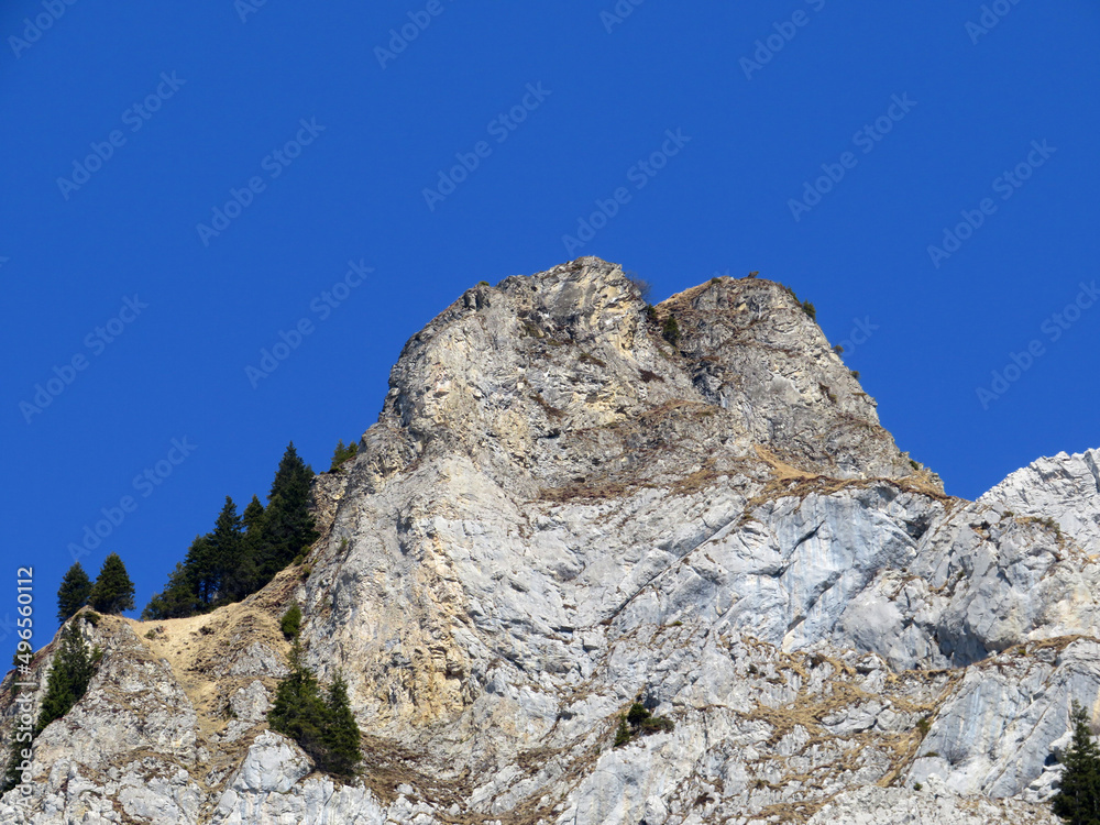 Rocky peak Dejenstogg or Dejenstock (2022 m) in the Glarus Alps mountain range, over the Klöntalersee (or Kloentalersee) reservoir lake and Klöntal alpine valley - Canton of Glarus, Switzerland