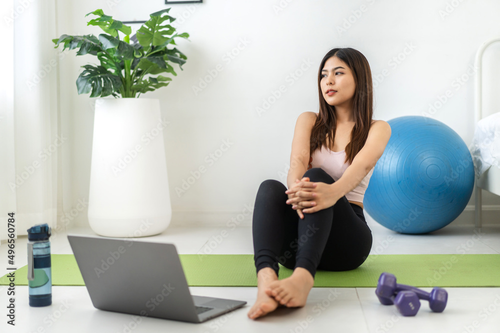 Portrait sport asian beauty body slim woman in sportswear sitting relax and girl practicing yoga and do fitness exercise with laptop computer in bedroom at home.Diet concept.Fitness and healthy Portrait sport asian beauty body slim woman in sportswear sitting relax and girl practicing yoga and do fitness exercise with laptop computer in bedroom at home.Diet concept.Fitness and healthy