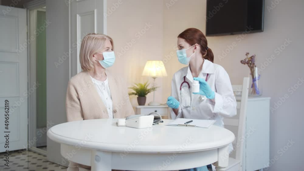 The doctor tells the old woman about new medicines. She tells when and how much to take them The doctor tells the old woman about new medicines. She tells when and how much to take them