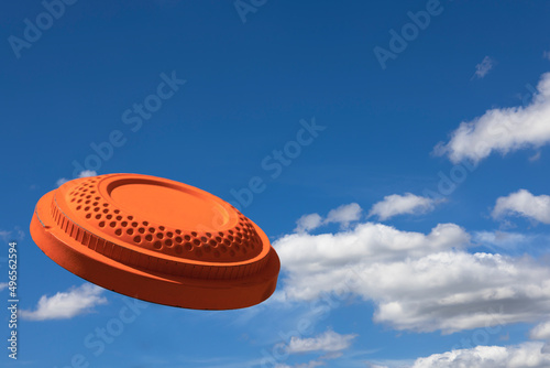 Flying clay pigeon target in the blue sky background , shotgun shooting game photo
