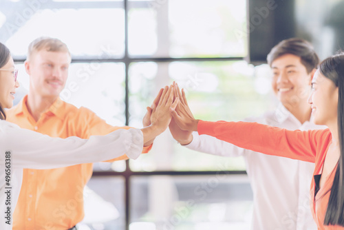 Collaboration Business Team success concept. happy business team giving high five as team together hands air greeting power tag team. Group of diversity people multiethnic unity togetherness in Volunt