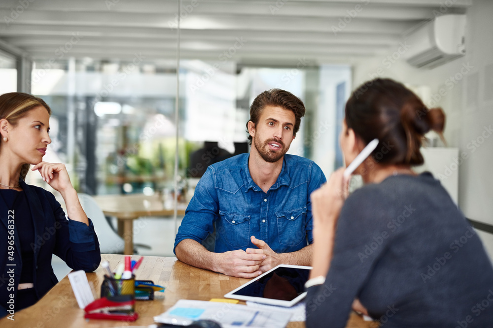Putting ideas on the table. Shot of a group of businesspeople having a meeting together in an office. Putting ideas on the table. Shot of a group of businesspeople having a meeting together in an office.
