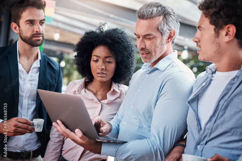 This is our we will execute our strategy. Shot of a group of businesspeople working together on a laptop outdoors. This is our we will execute our strategy. Shot of a group of businesspeople working together on a laptop outdoors.