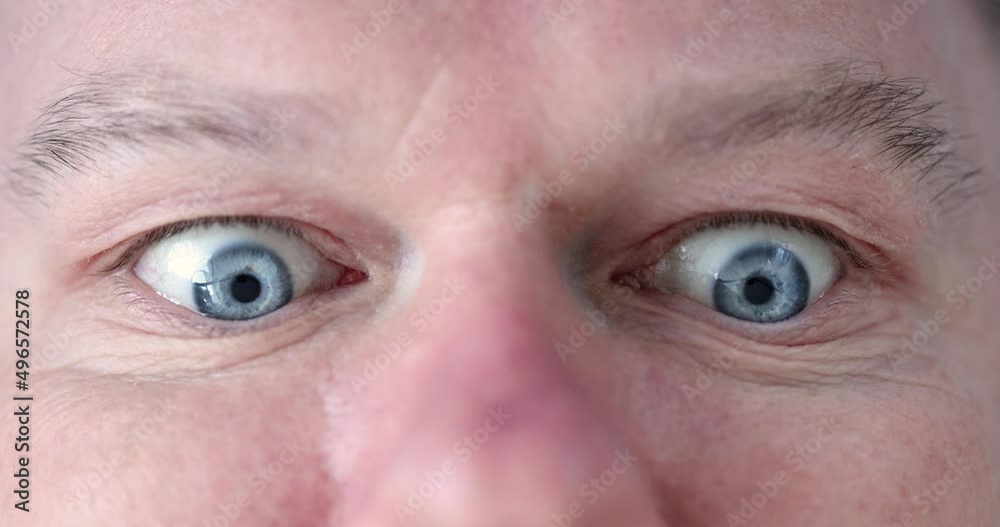 Man with blue eyes does gymnastics for eyes closeup Man with blue eyes does gymnastics for eyes closeup