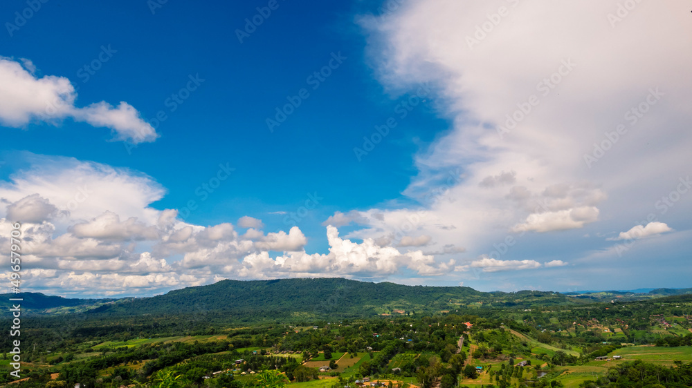 Obraz premium Beautiful landscape mountain green field grass meadow white cloud blue sky on sunny day. Majestic green scenery big mountain hill cloudscape valley panorama view in countryside greenery pasture