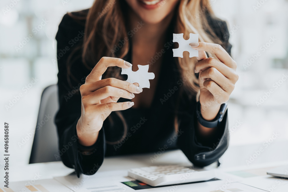 Businesswoman holding a two piece puzzle to shape, running a startup company, strategizing to make the business grow and be profitable. Concept of execution, strategy planning and profit management.