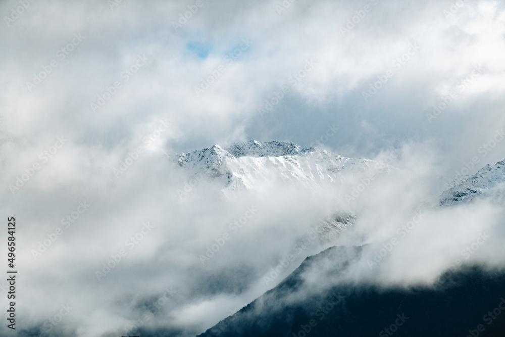 Snow covered peaks with clouds
