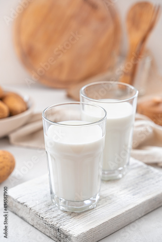 Two glasses of potato milk with raw potatoes on a white background. Vegetarian milk.