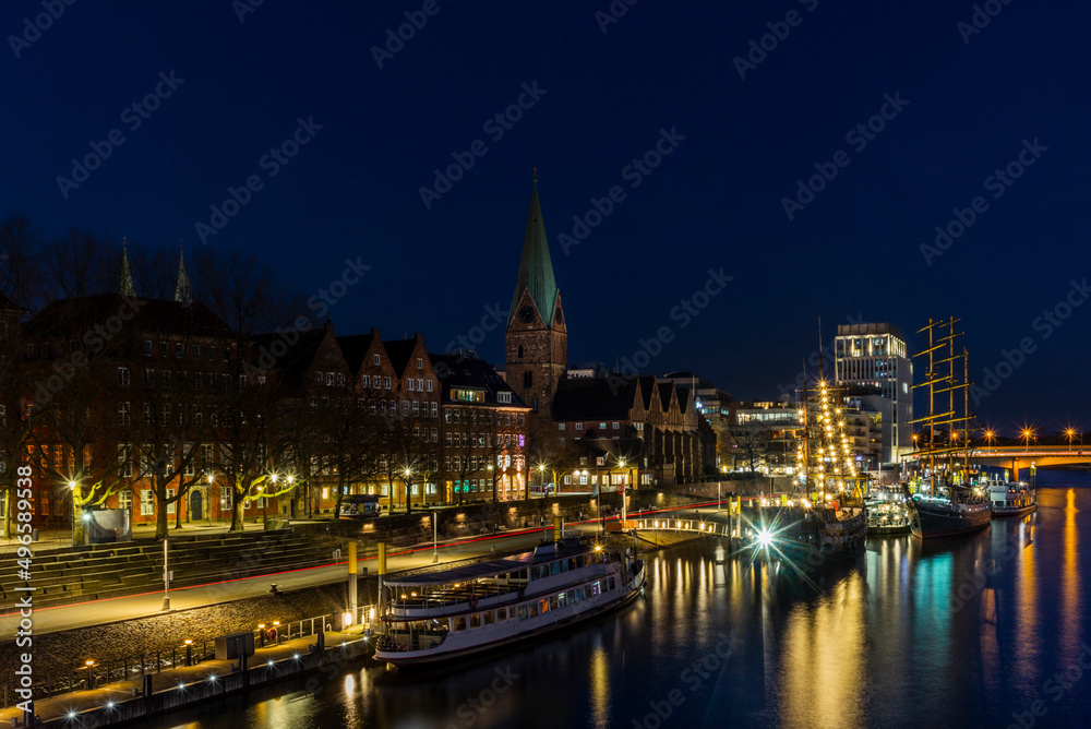 Night view of Bremen with the buildings, bridges and ships reflecting in the river