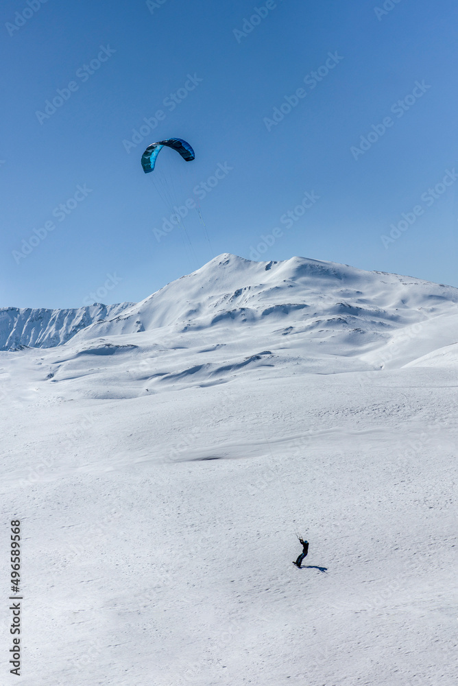 Snow kiting on the alps near Lenzerheide during a sunny winter day