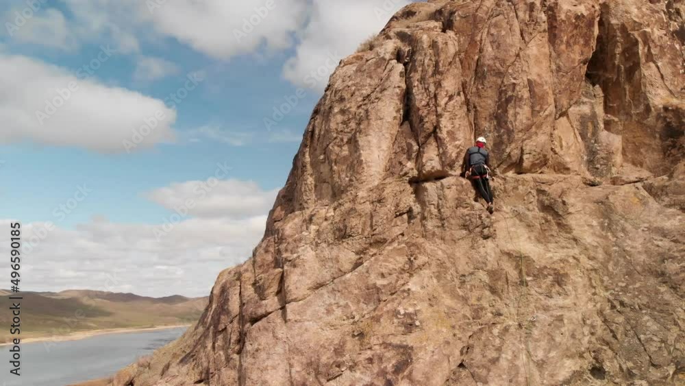 Man athlette climbing on the high rock Man athlette climbing on the high rock