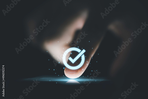 Photography Hand touching to screen with tick correct mark to approve document and project concept
