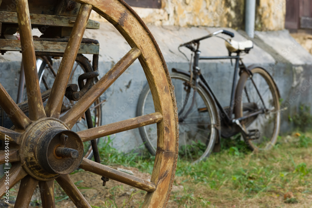 Bulllock carth wheel and old rusty bicycle