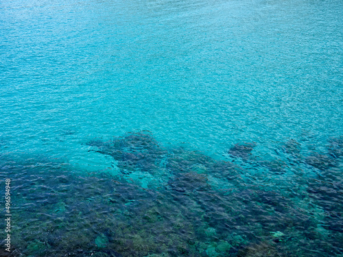 Turquoise sea background with copy space. Clean and transparent water in the Mediterranean sea. Rocks under the water. Majorca, Balearic Islands, Spain