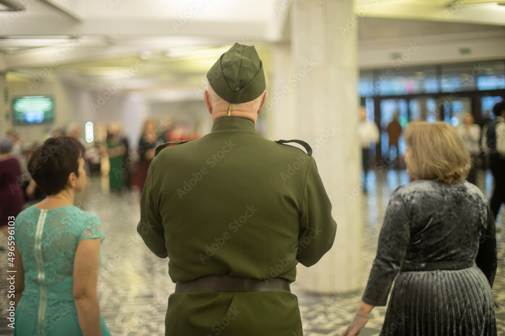 Fototapeta premium Old man at meeting of graduates. Seniors at event. Dancing friends.