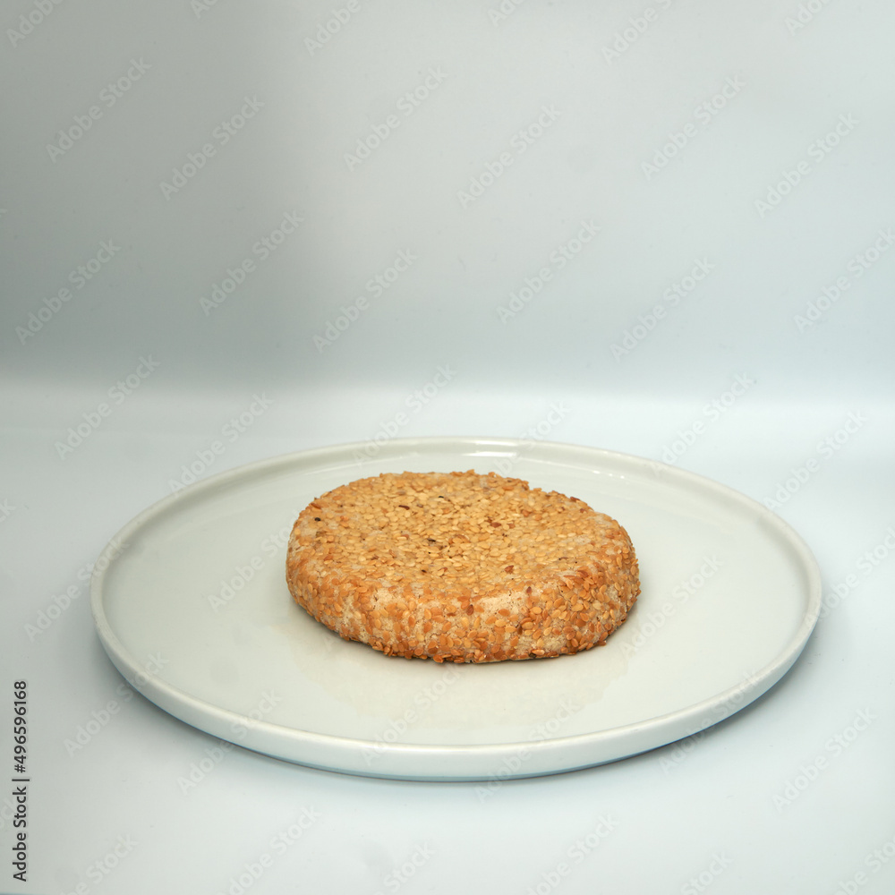 Sesame cookie on a plate on wihte isolated background. Sesame cookie on a plate on wihte isolated background.