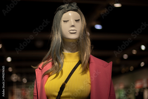 Mannequin girl. Fashion show on mannequin. Figure of man in store. Hairstyle with green tint.