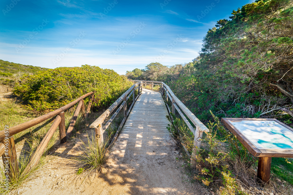 Wooden boardwalk in Andreani cove on a sunny day
