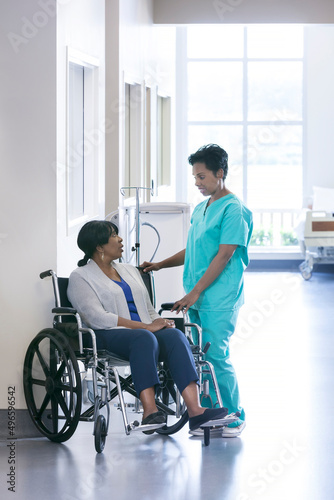 African American female nurse and disabled wheelchair patient medical centre