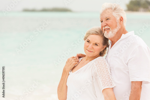 Happy Caucasian couple in white clothes on a Caribbean beach