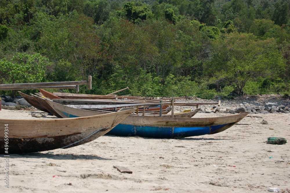 Small wooden fishing boats with paddles on a sandy beach in Vietnam. Small wooden fishing boats with paddles on a sandy beach in Vietnam.
