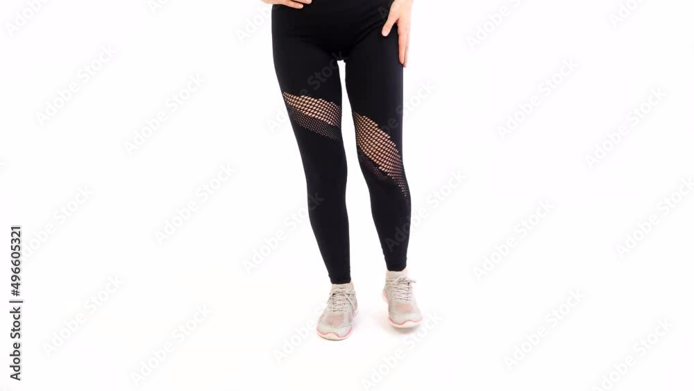 Athletic Girl in Sportswear is Training Flexing Legs. Workout, Sport, Fitness, Training and Wellness Concept on White Background Athletic Girl in Sportswear is Training Flexing Legs. Workout, Sport, Fitness, Training and Wellness Concept on White Background