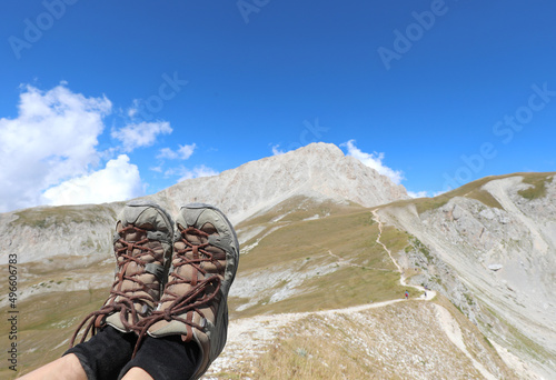 two trekking shoes and the panorama of the Gran Sasso the huge mountain of the Abruzzo region in Italy