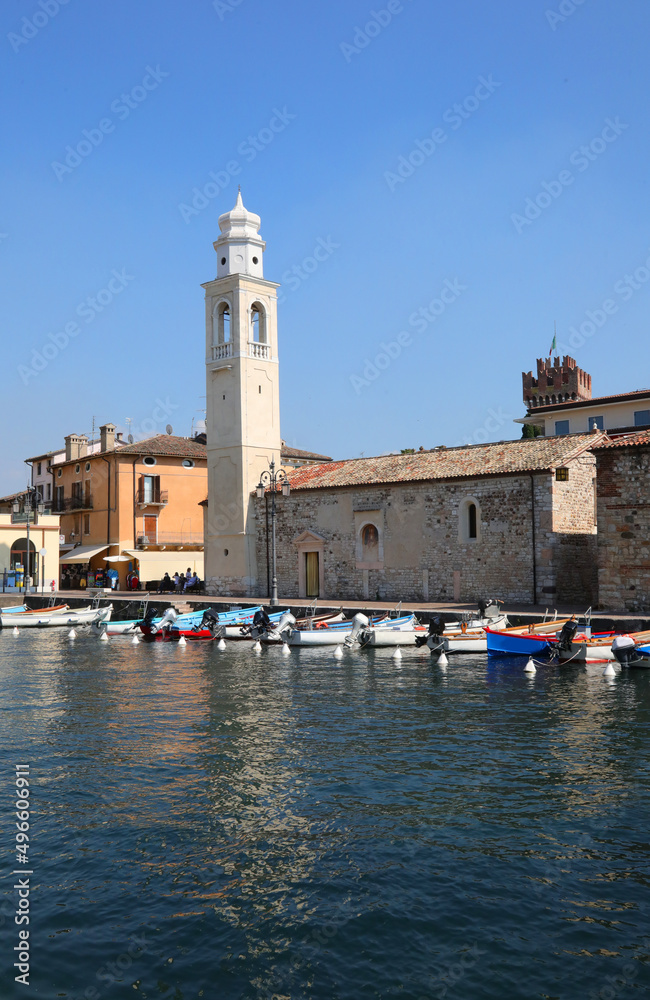 Fototapeta premium Lazise city is a small village on Lake Garda in Italy with a church and a small harbor with boats