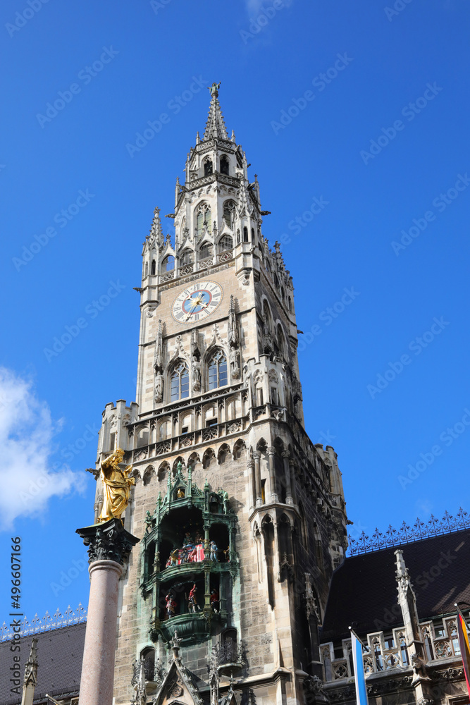 high tower with clock of the Munich Town Hall in Germany and the sky in the background