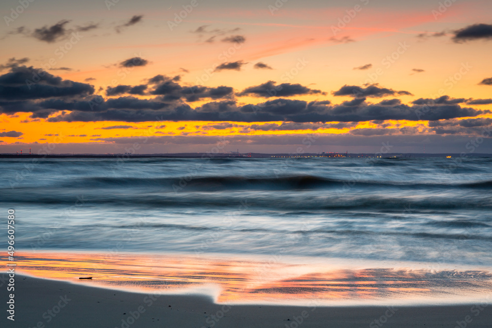 Naklejka premium A beautiful sunset on the beach of the Sobieszewo Island at the Baltic Sea. Poland